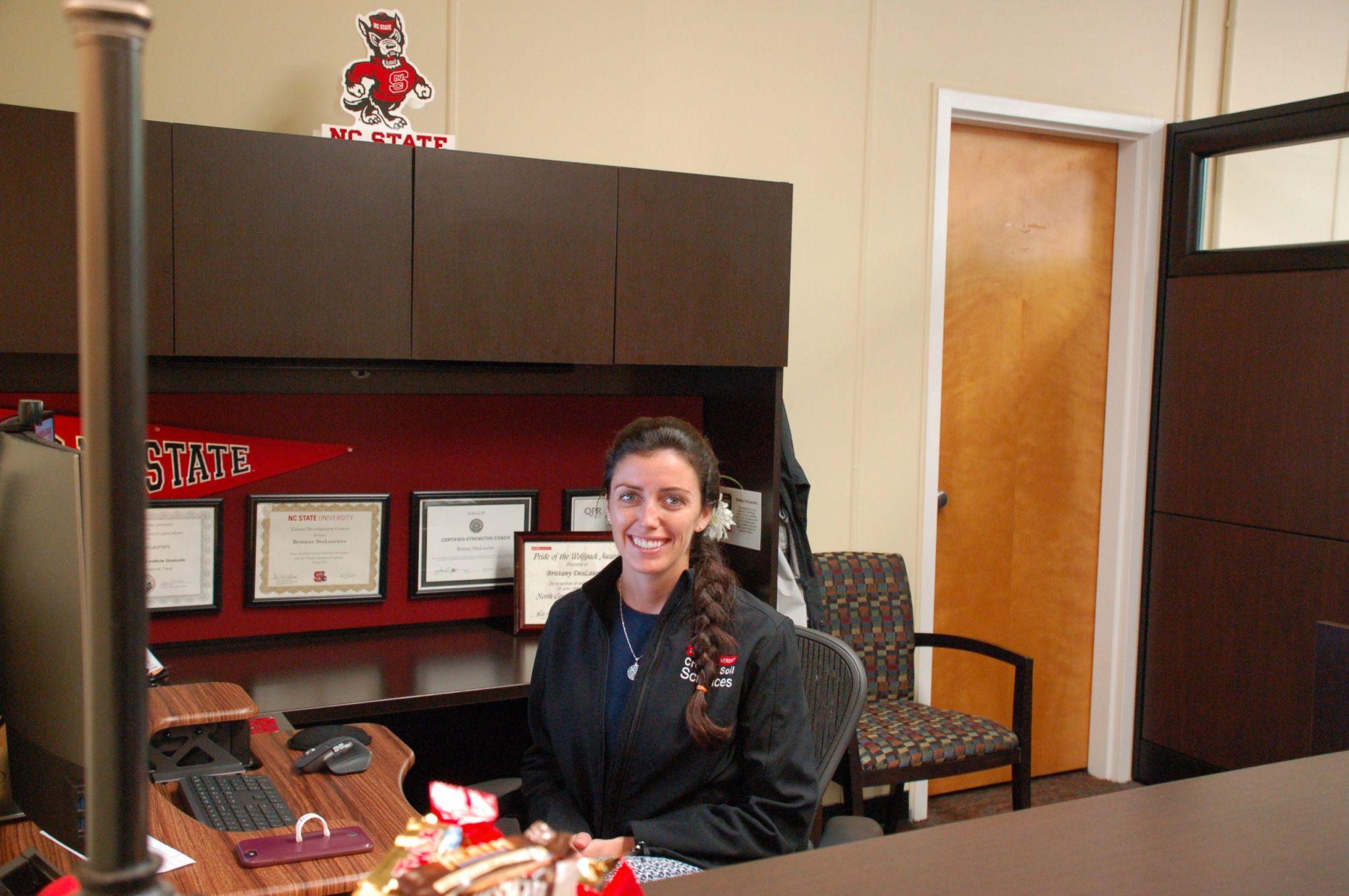 A woman sitting at a desk at NC State's Department of Crop and Soil Sciences