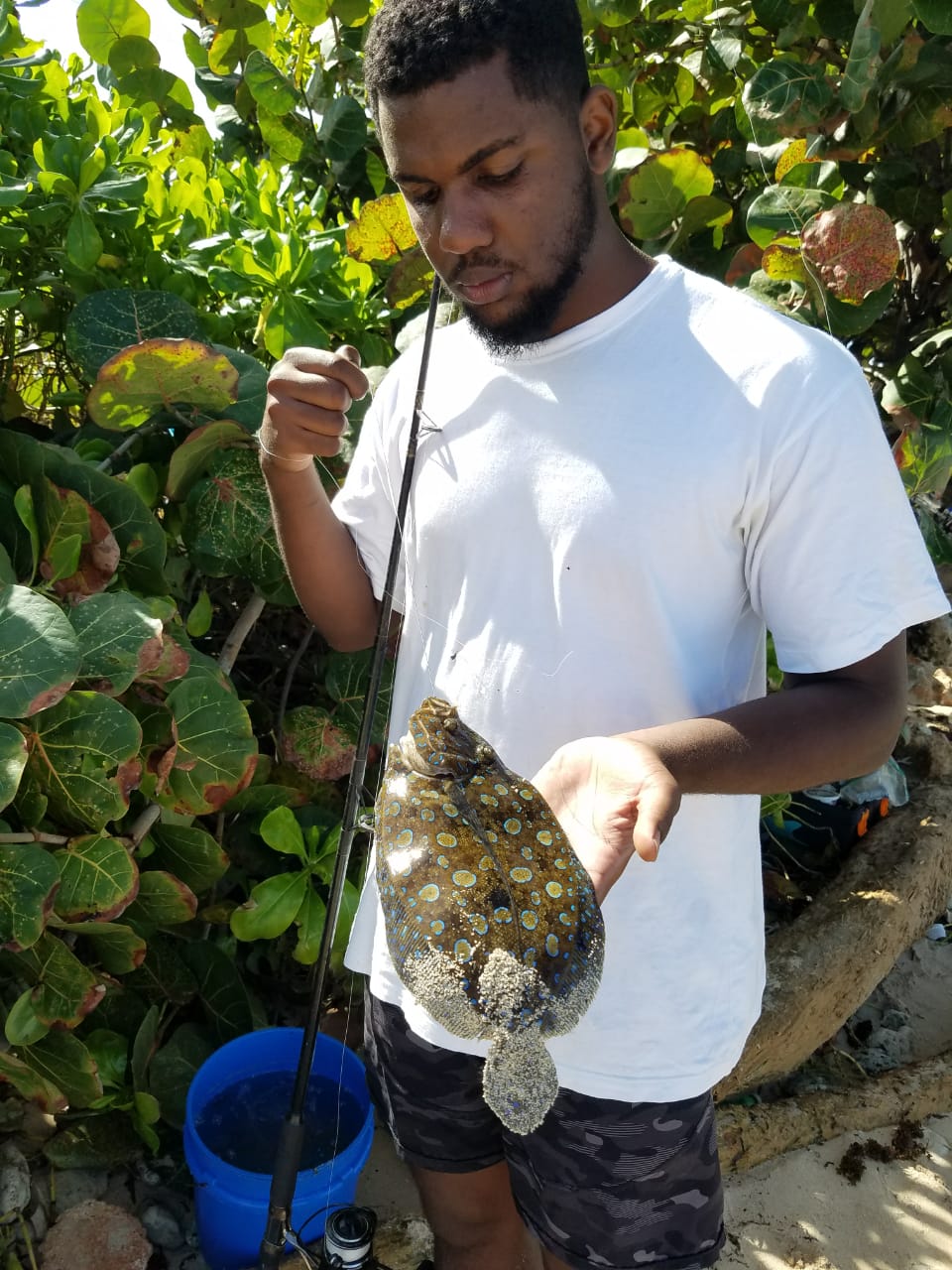 Jaleel Hewitt shows off a freshly caught fish.