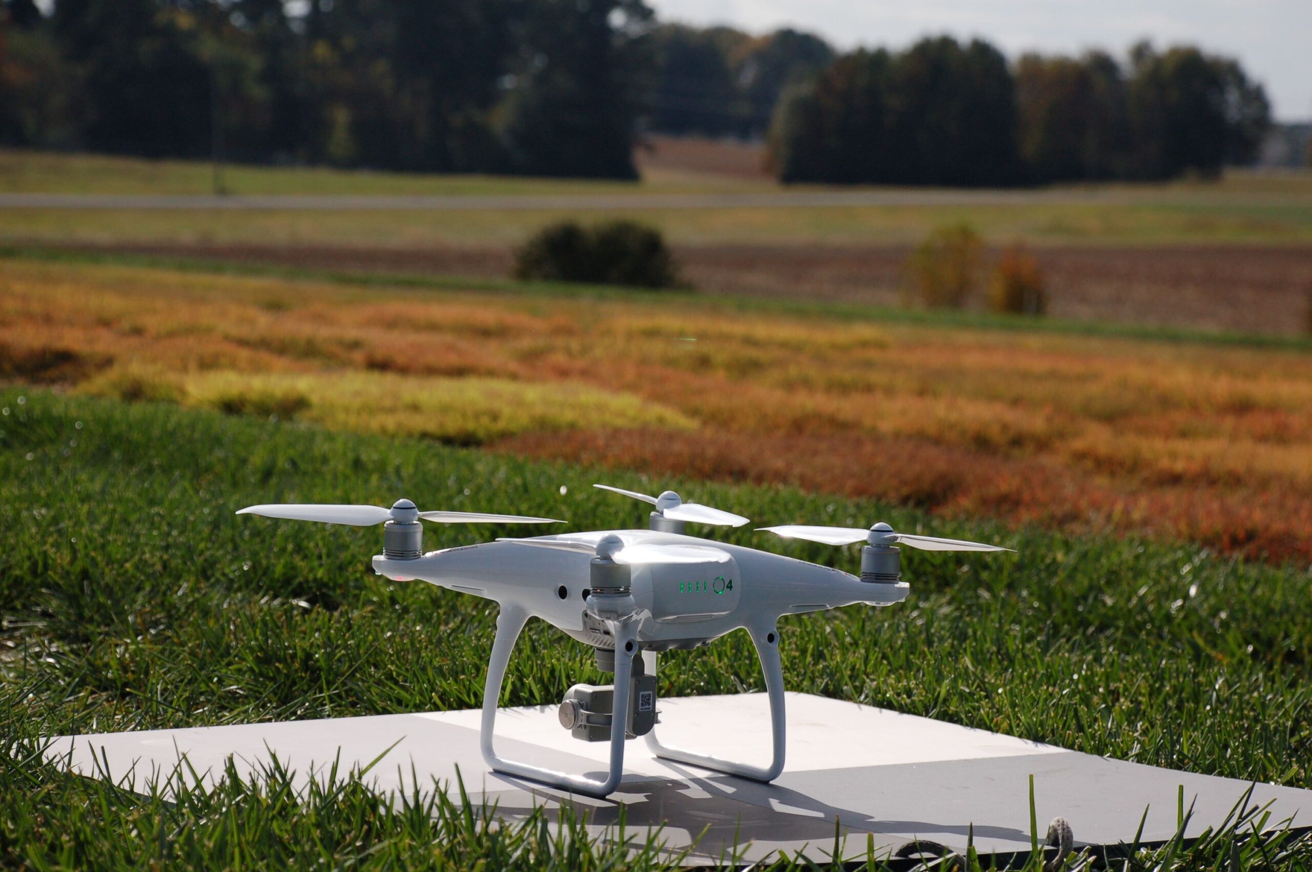 A drone sits on a landing pad at the NC State Turfgrass Field Lab