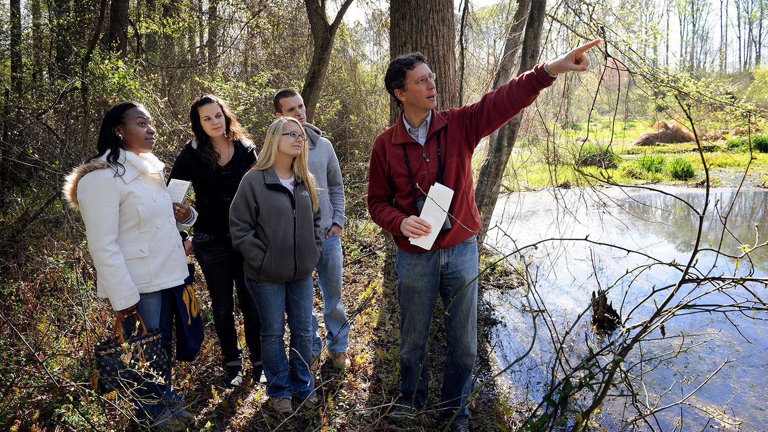 Nick Haddad in field with students