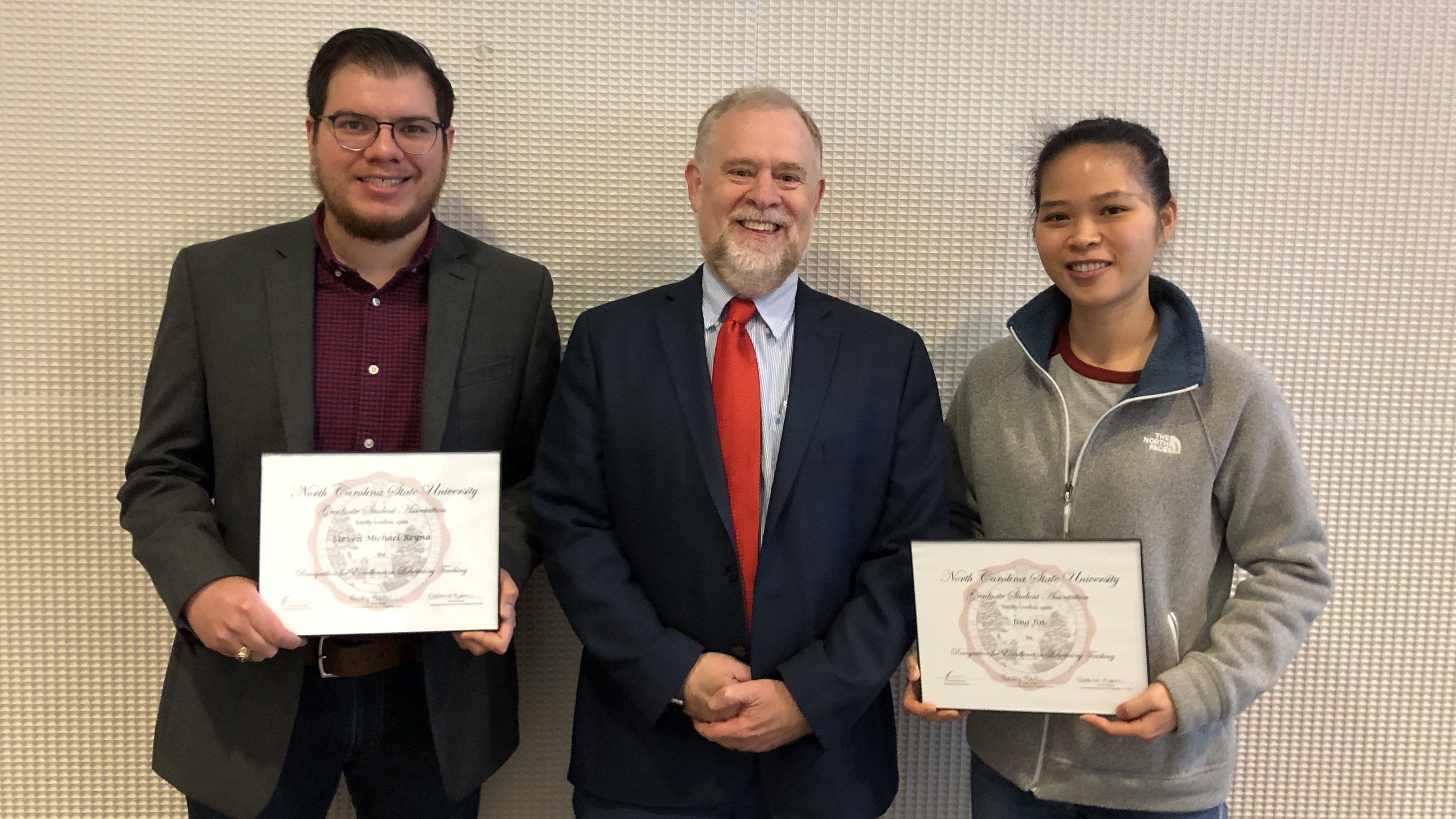 Steven Reyna and Jing Jin with the Dean of the Graduate School, Dr. Peter Harries