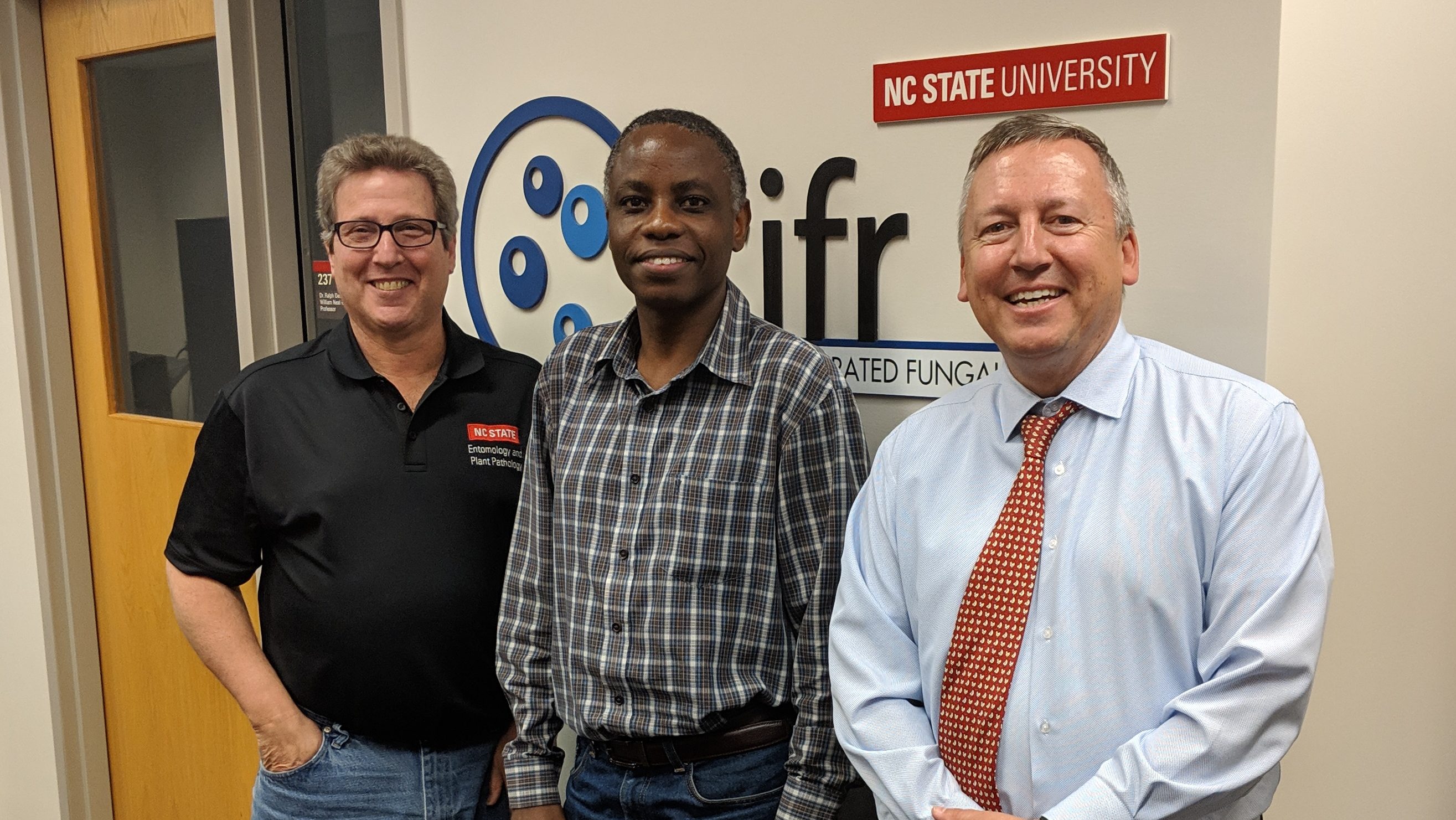 Dr. Ojiambo stands with Department Head, Dr. Eric Davis, and Dean Linton.