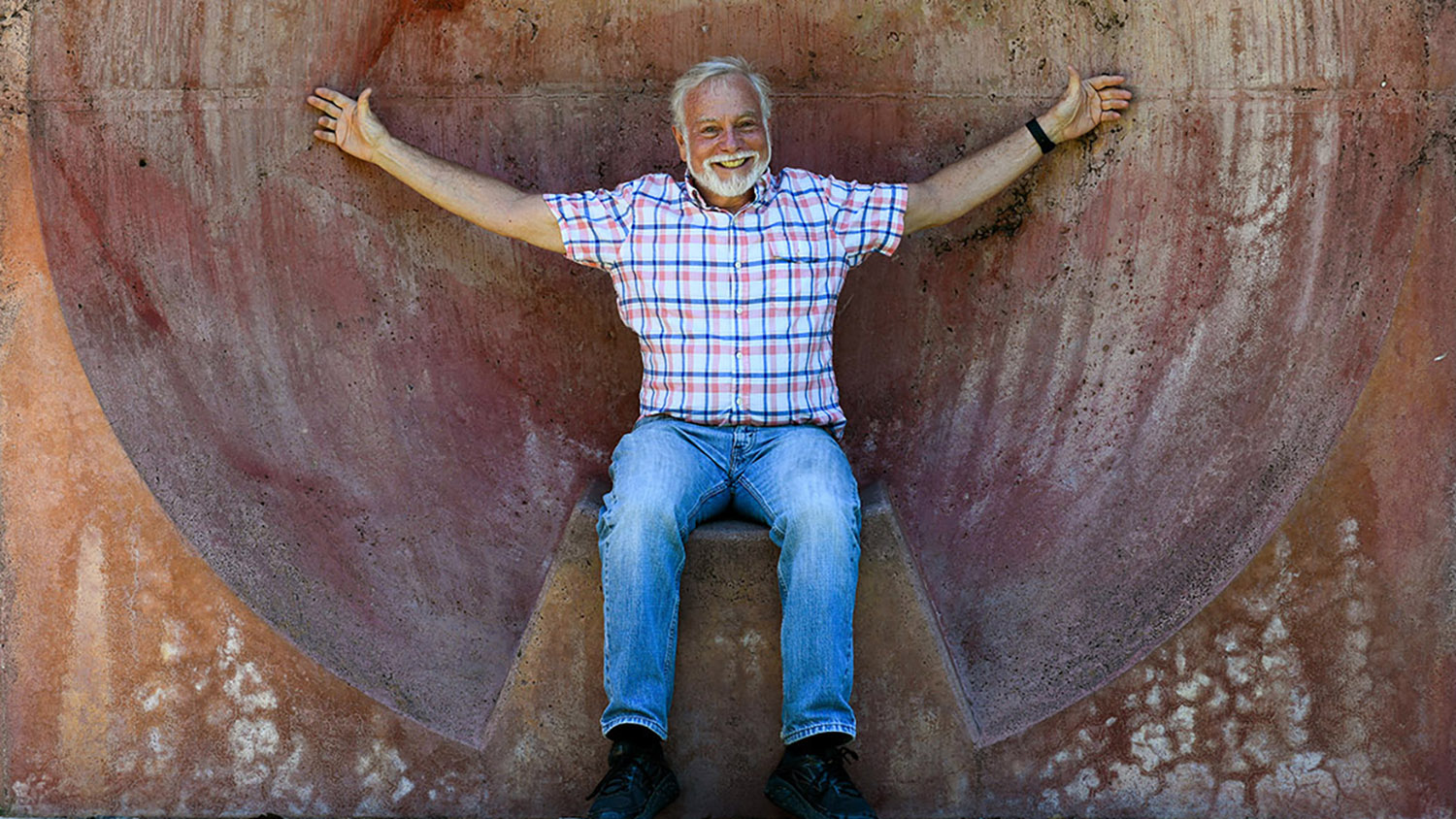 Photo of man with arms outstretched.