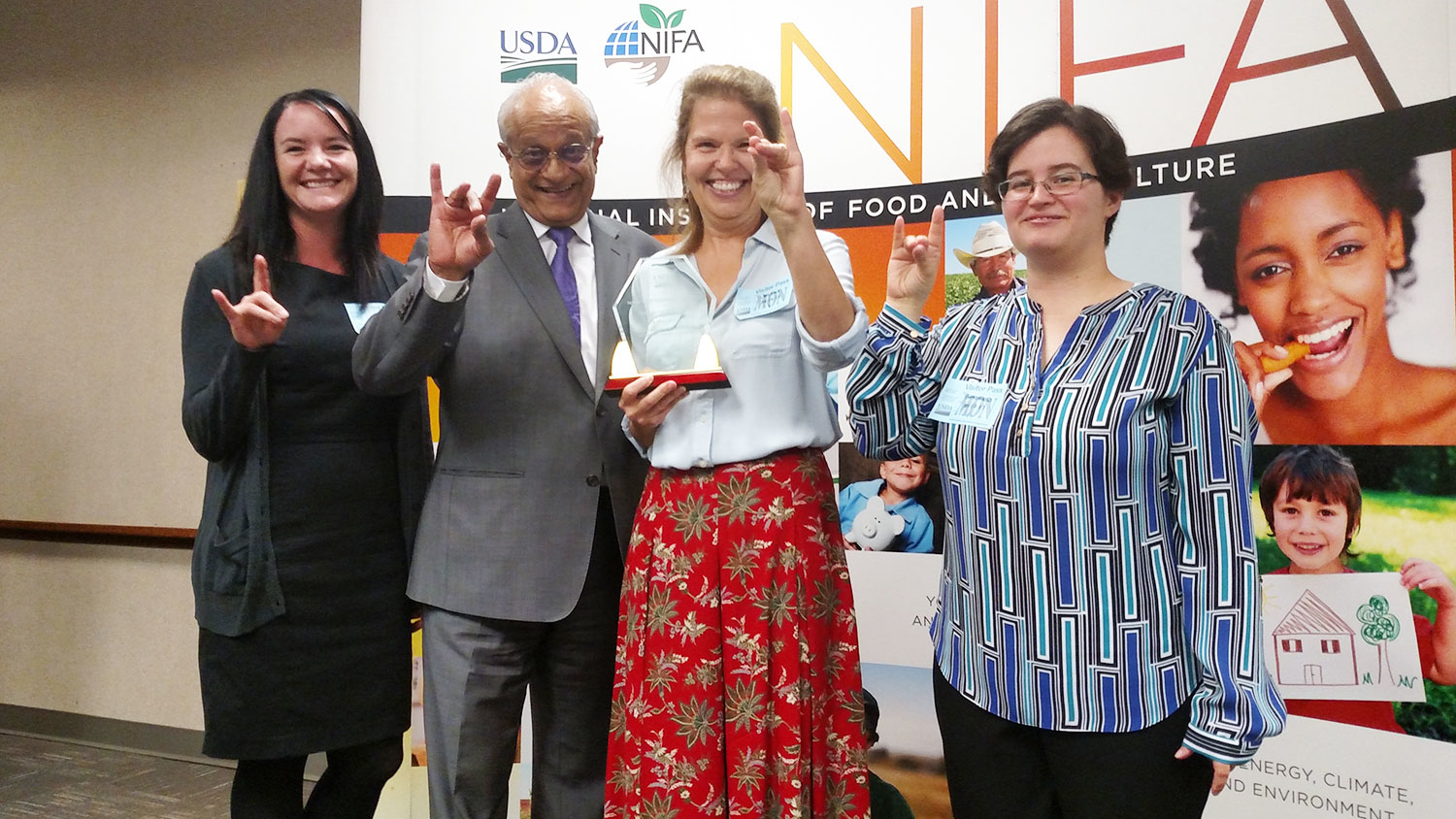Celebrating Wolfpack-style at the NIFA awards ceremony were (left to right): Rebecca Goulter, NoroCORE assistant director; Sonny Ramaswamy, NIFA director; Lee-Ann Jaykus, NoroCORE director; and Elizabeth Bradshaw, NoroCORE communications director.