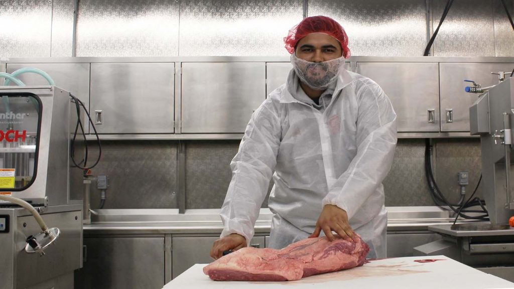 man processing meat