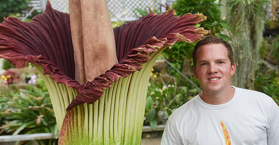 Brandon Huber standing with Lupin, the corpse flower.