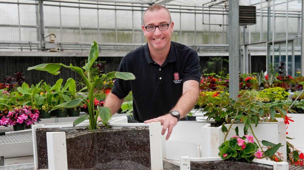 Dr. Brian Jackson displaying a plant wood substrate trial.