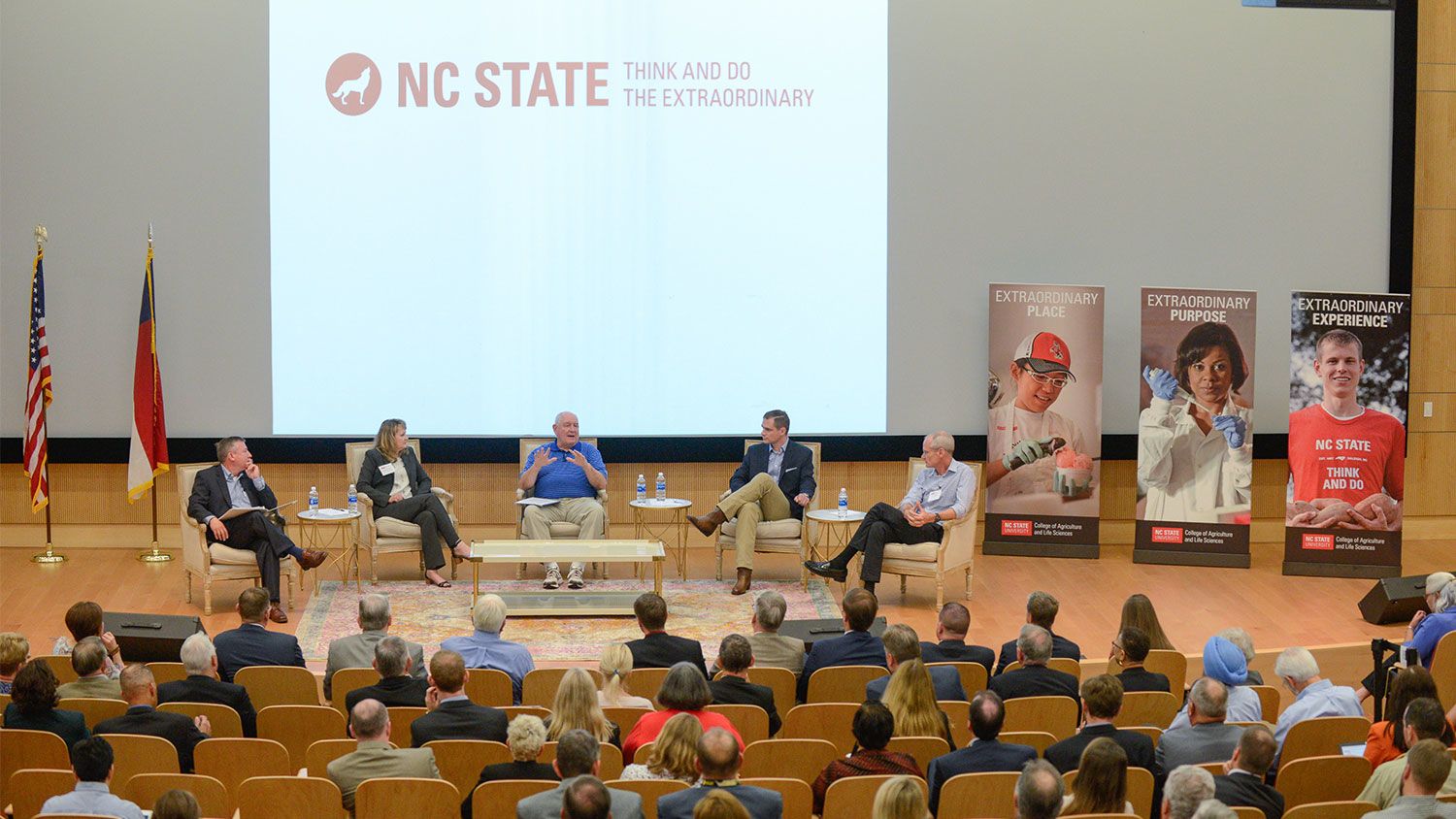 Panelists on stage in the Hunt Library auditorium.