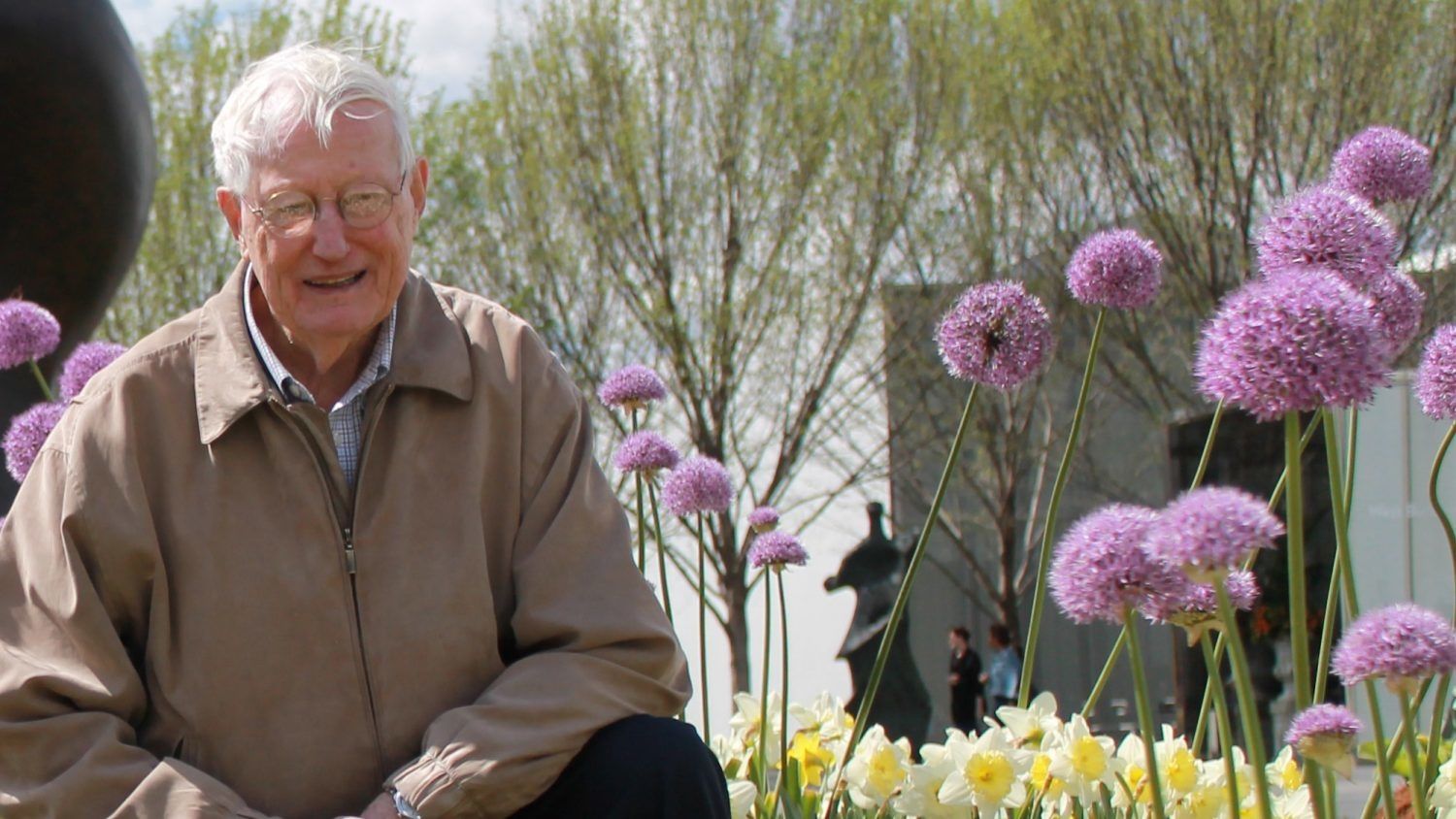 Gus De Hertogh surrounded by flowers.