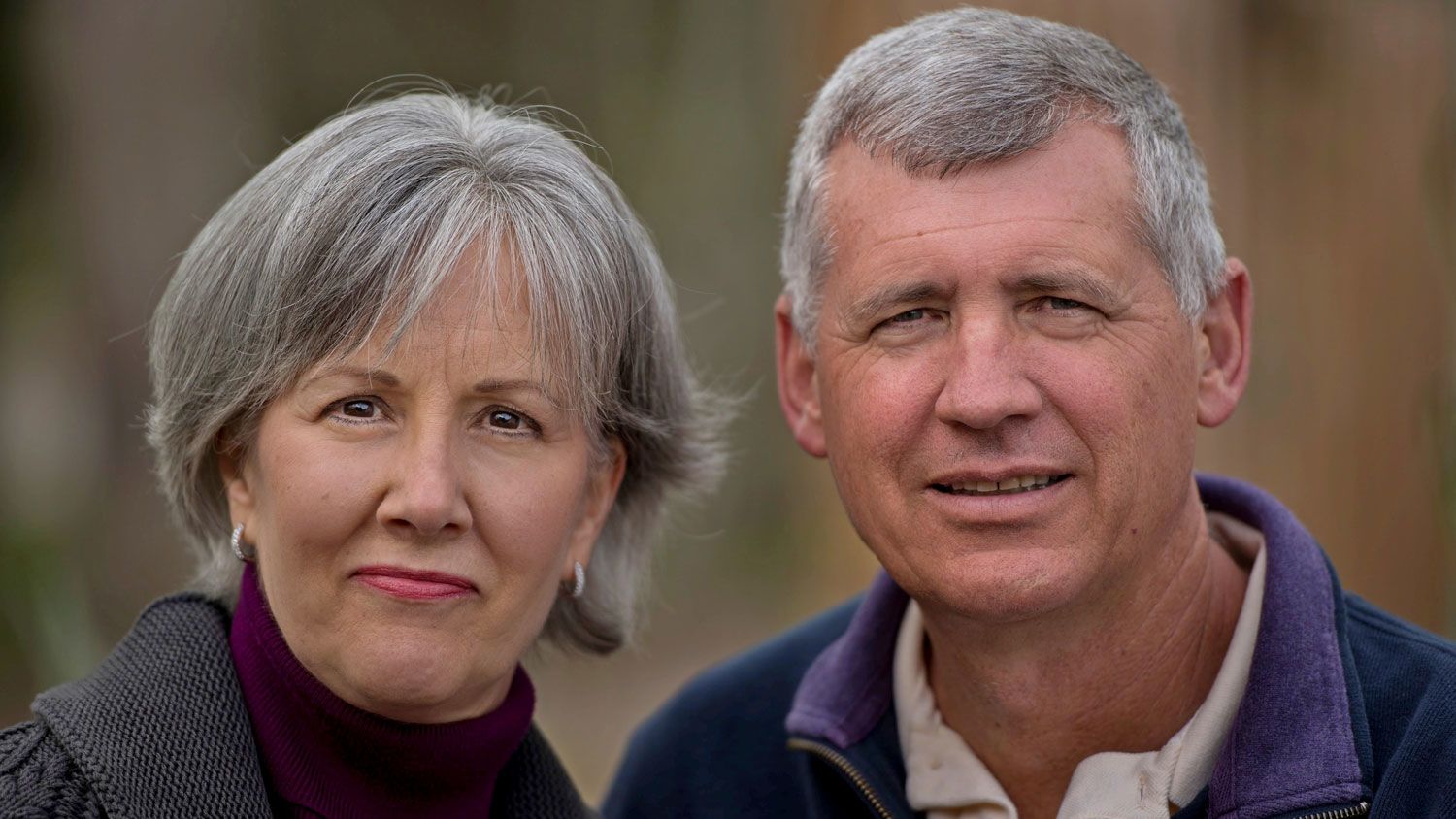 An older couple posing together for a photograph