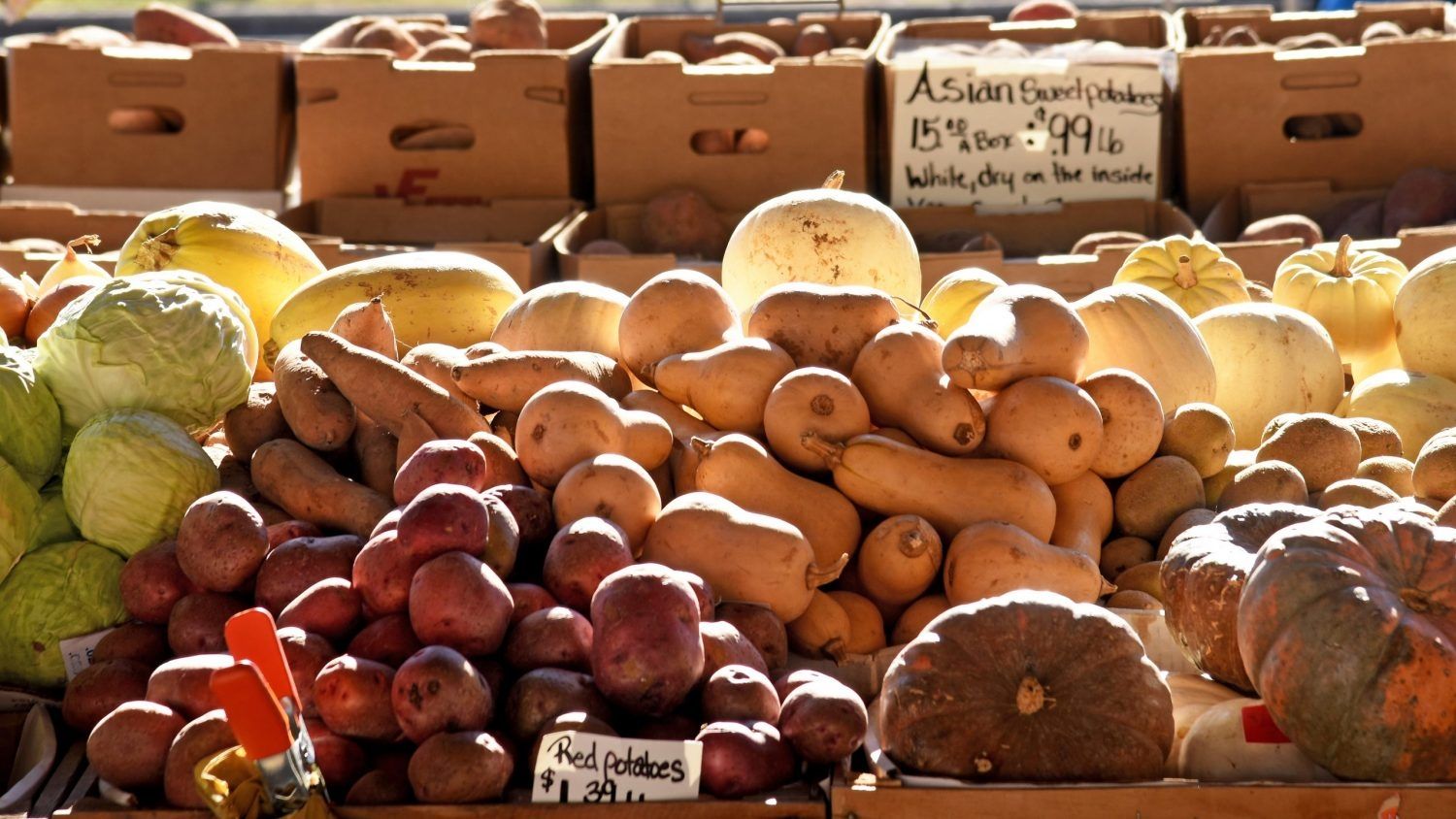 Grounds and other produce displayed at a farmers market stand