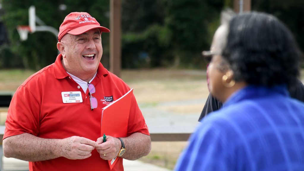 Rich Bonanno speaking to a person at an outdoor event