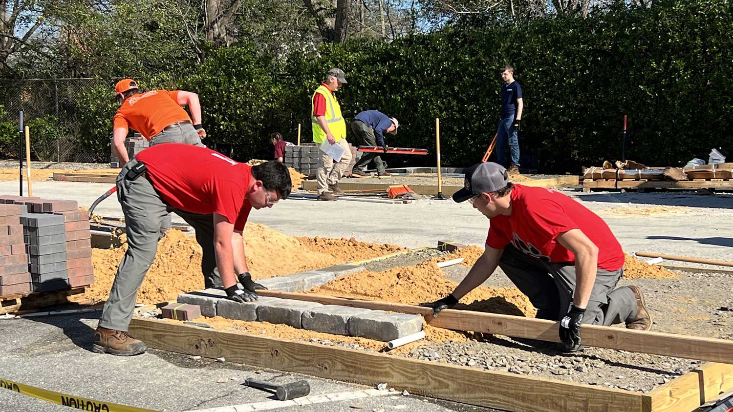 Mason Davis and Andrew Quate level a surface in the hardscape installation event.