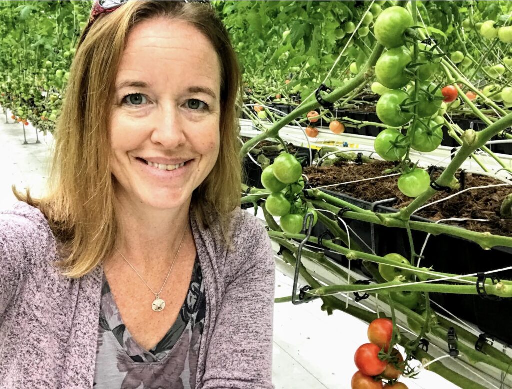 Lisa Rayburn with greenhouse tomatoes