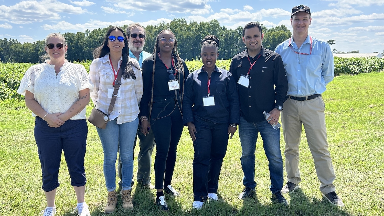 Seven people standing in a field