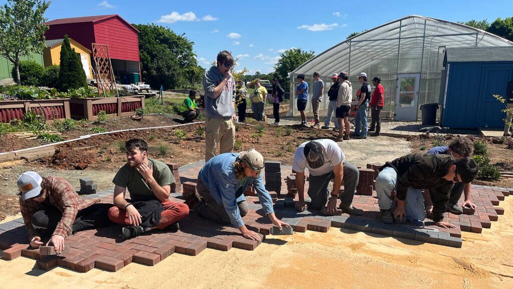 Students landscape design and build studio's paver project.