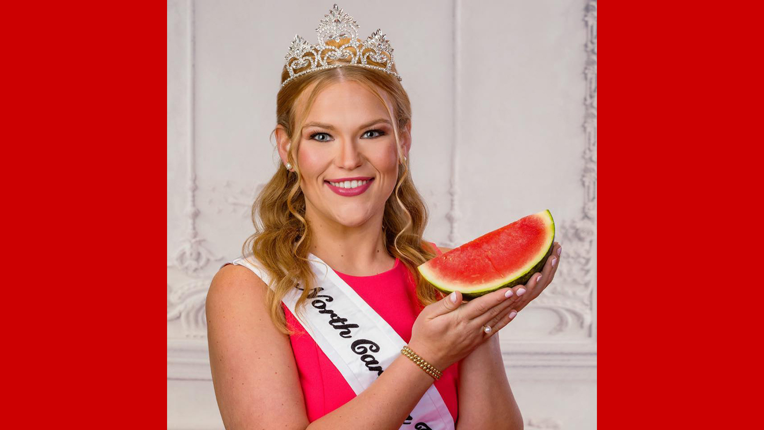 a woman wearing a tiara holding a slice of watermelon