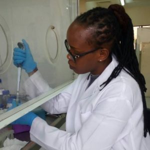 NC State Borlaug Fellow Dr. Anne Njoroge, Research Associate, Crop and System Sciences Division, International Potato Center, Nairiobi - Kenya pipetting in the lab