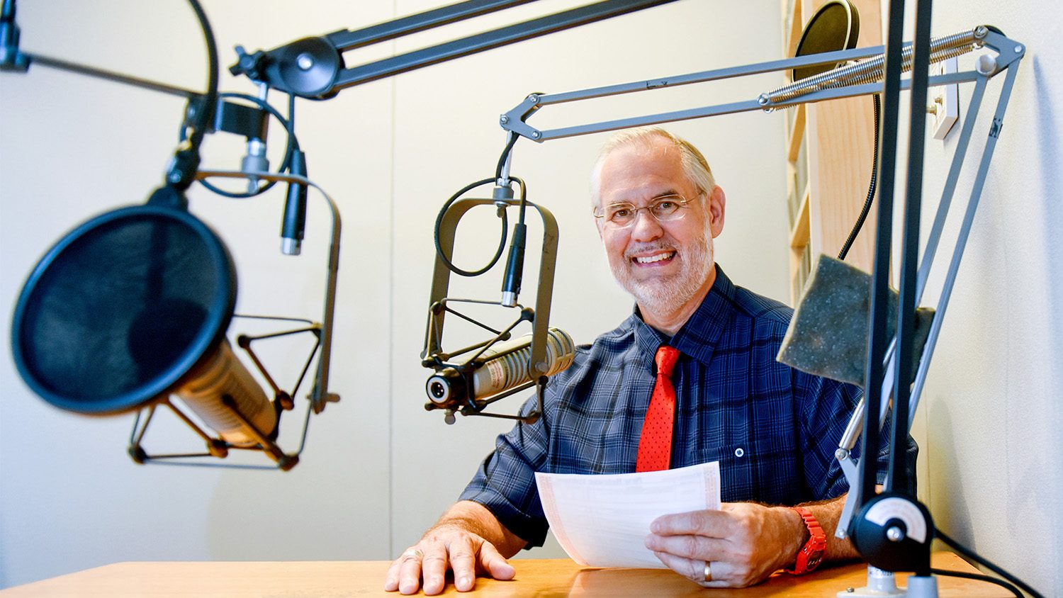 White male with large wallmounted microphone.