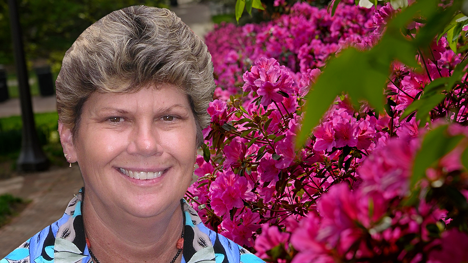 Woman's head standing next to flowers