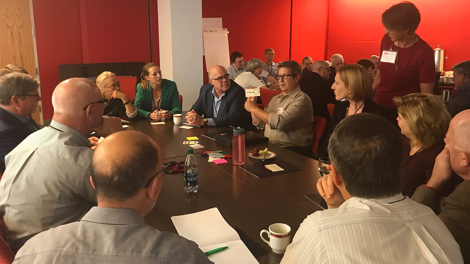 Scientists and administrators gathered around tables.