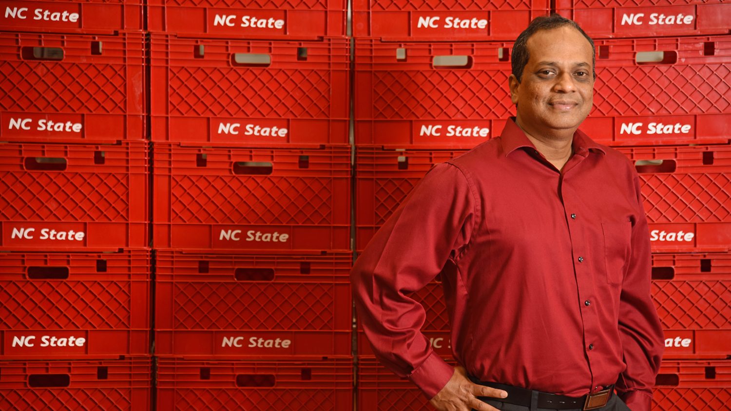 FBNS Department Head K.P. Sandeep standing in front of NC State milk crates