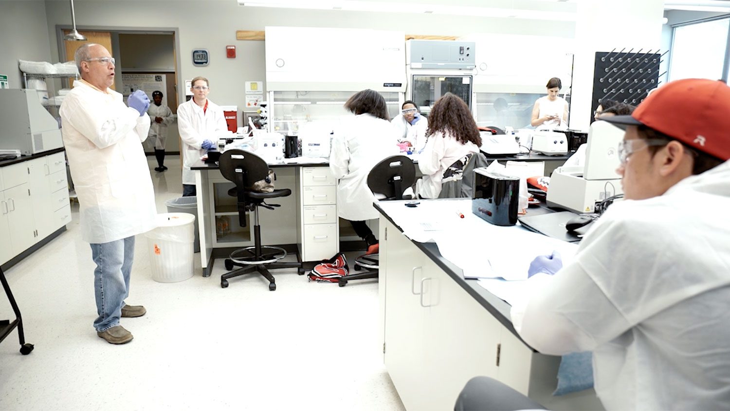 Students in a lab listening to an instructor