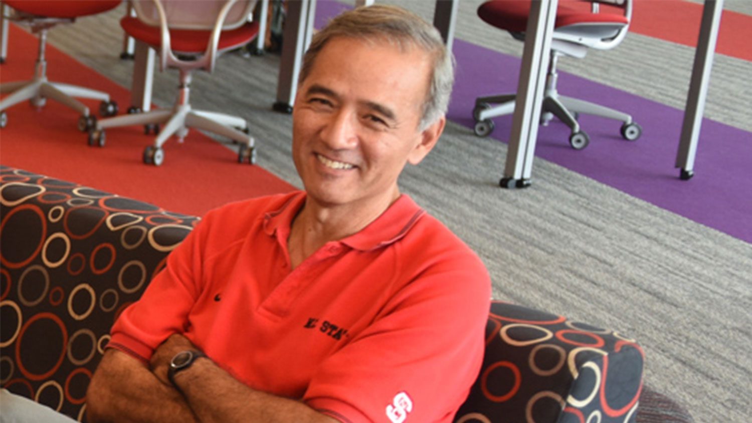 Male faculty member smiling during a meeting