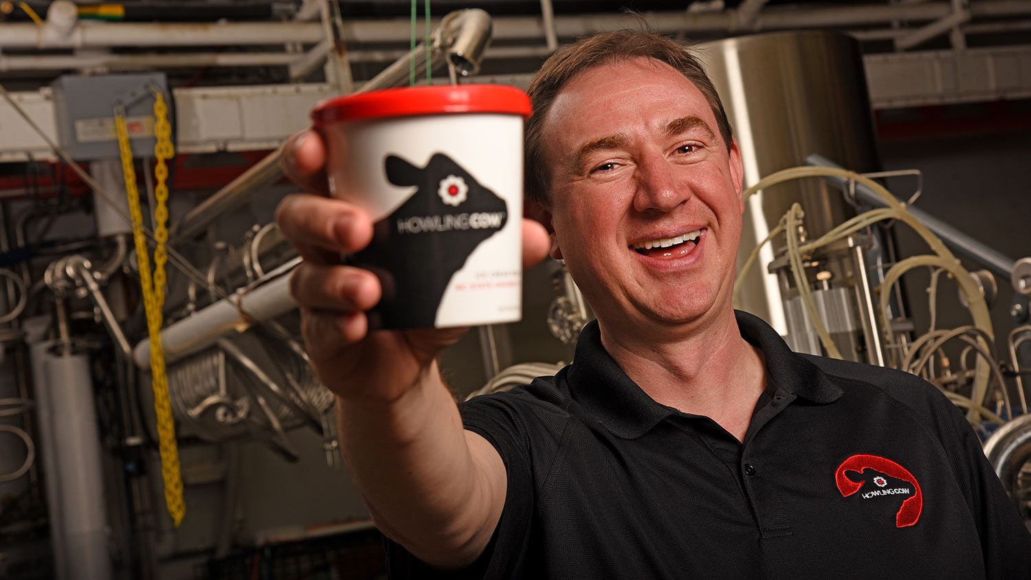 Carl Hollifield holding a container of Howling Cow ice cream