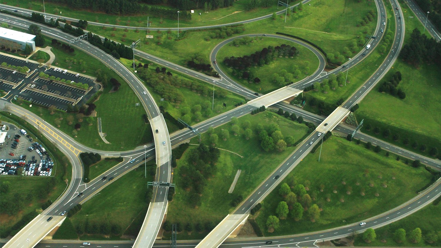 Aerial shot of road ways and green grass