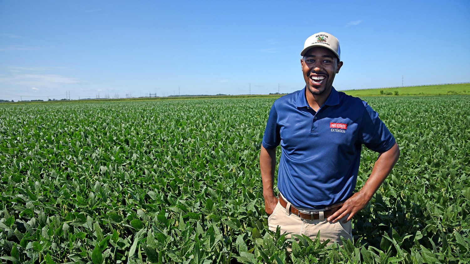 Extension employee standing in a field