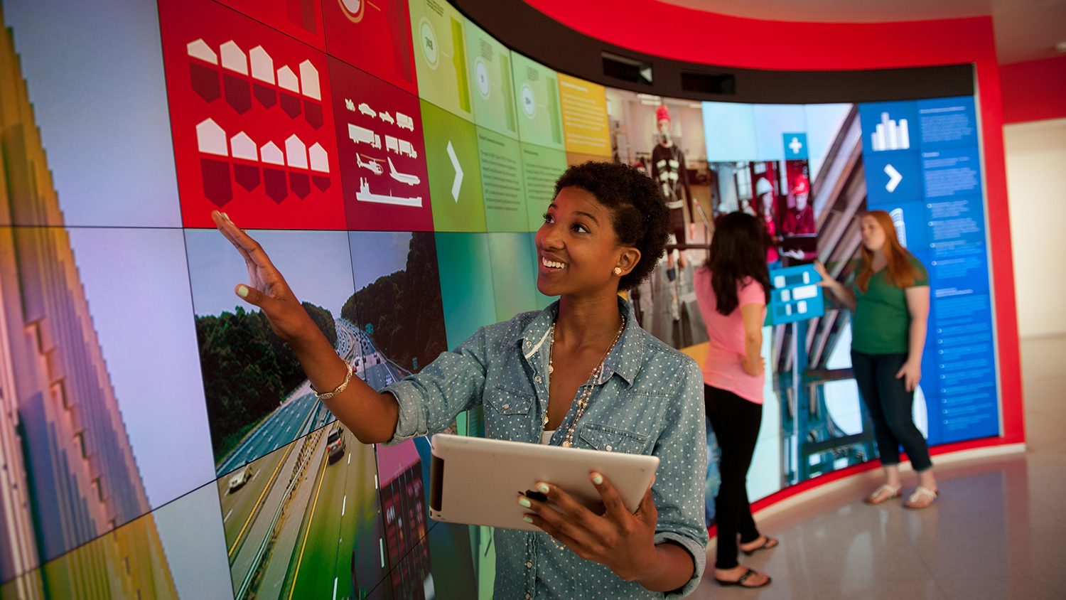 Black female student in front of a large screen