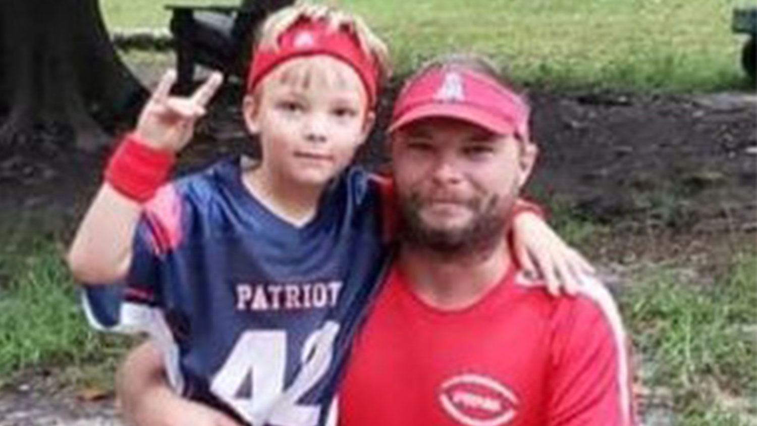 Little boy and man posing for a picture