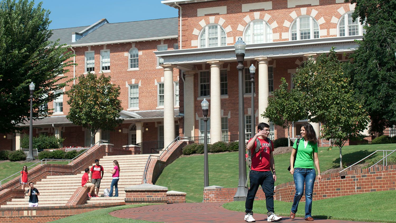 Students walking on NC State's campus near the 1911 Building