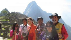 Machu Picchu in the background with family of six in the forefront