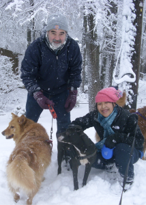 Man with beard and girl with pink hat in the snow