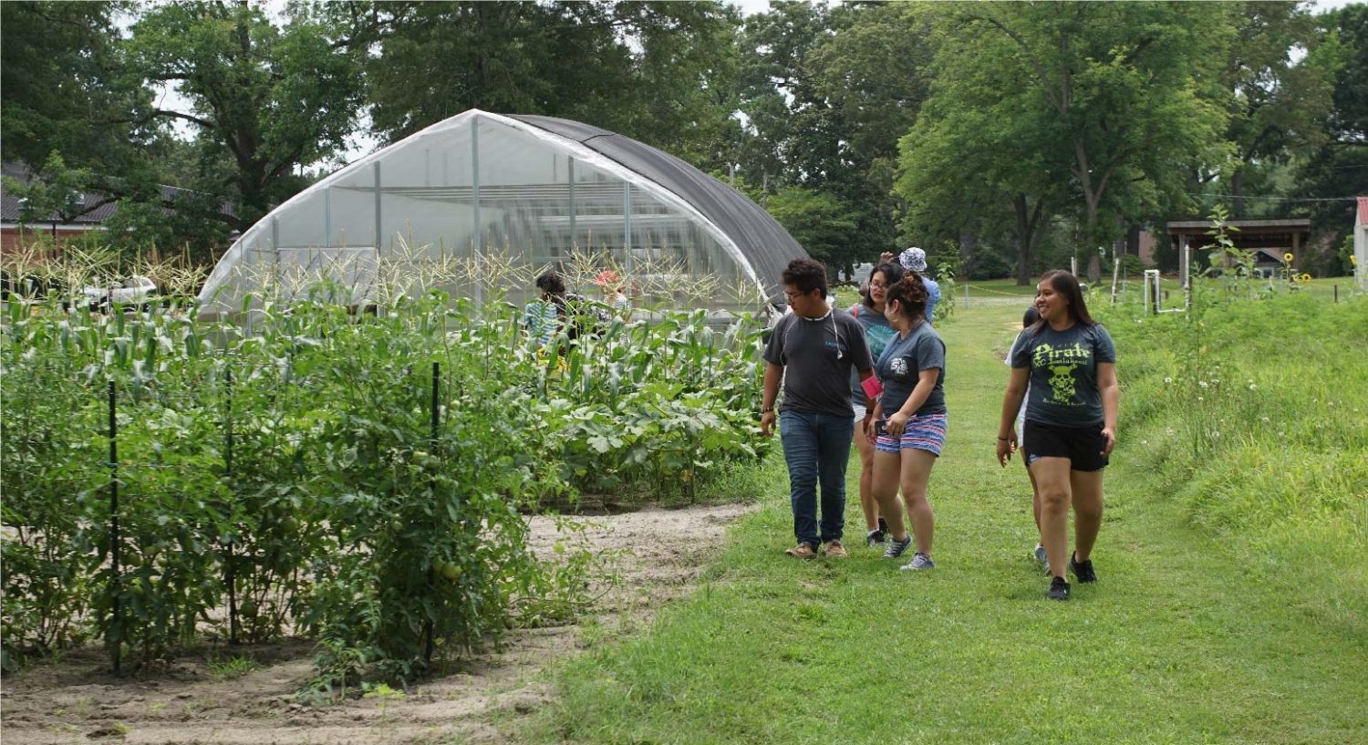 Group of latinx students on a small farm