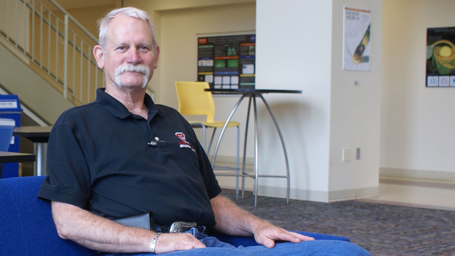 Gary Gregory seated on a couch in Riddick Hall.