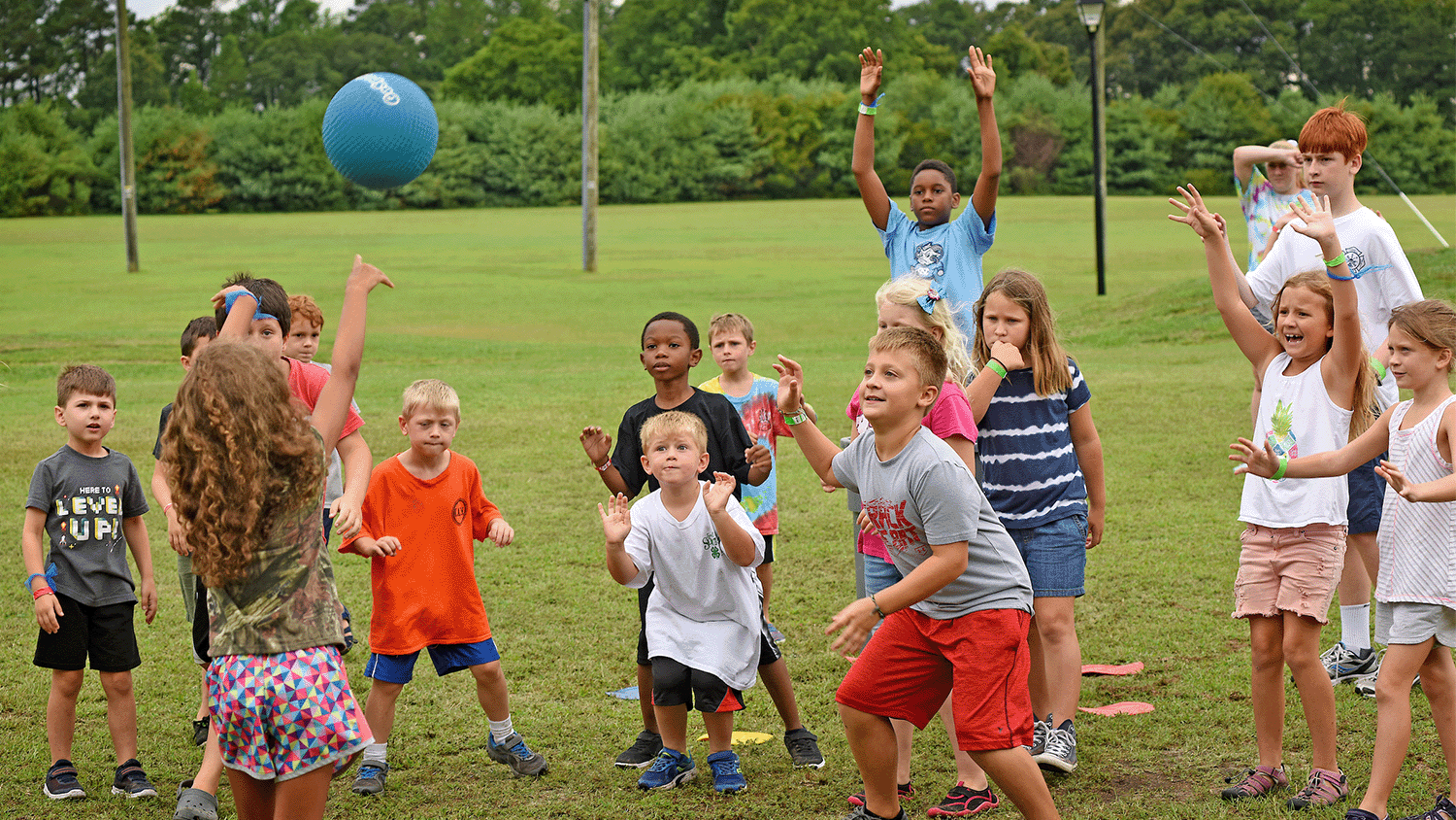 Kids playing in a field at a 4-H camp