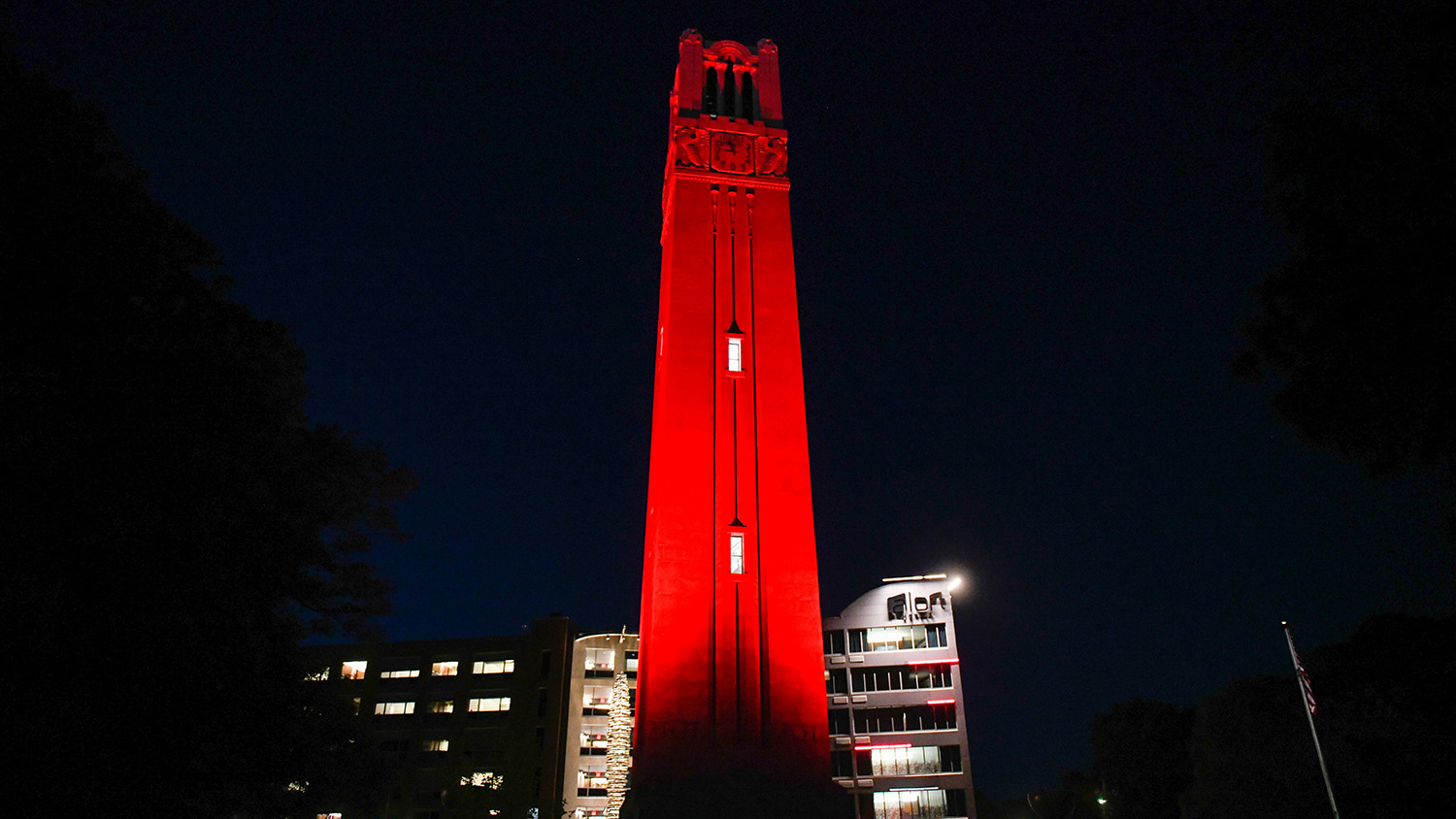 The Memorial Belltower glows red in honor of the spring 2021 graduates. Photo by Becky Kirkland.