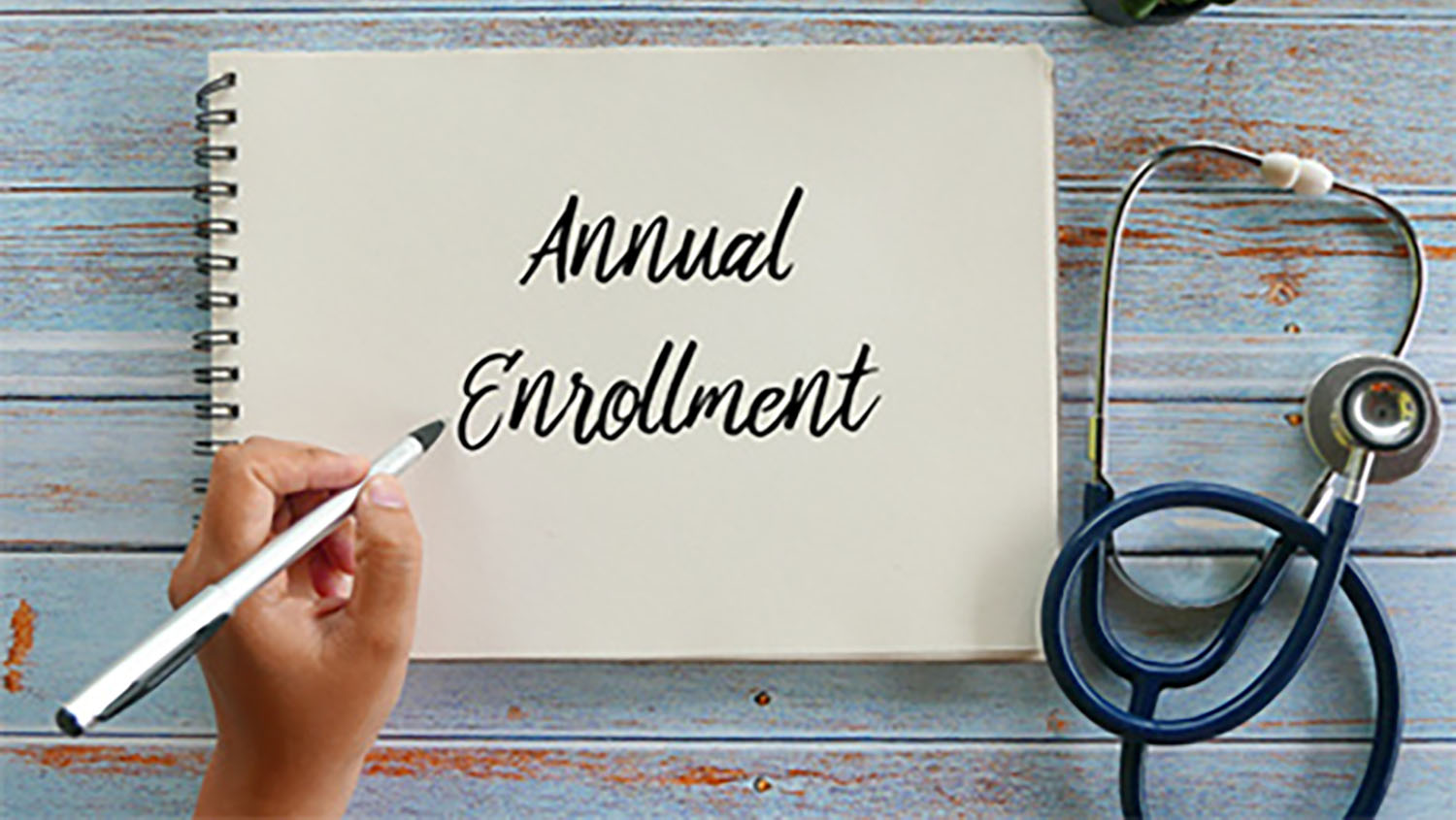 a note pad with the words annual enrollment written on it