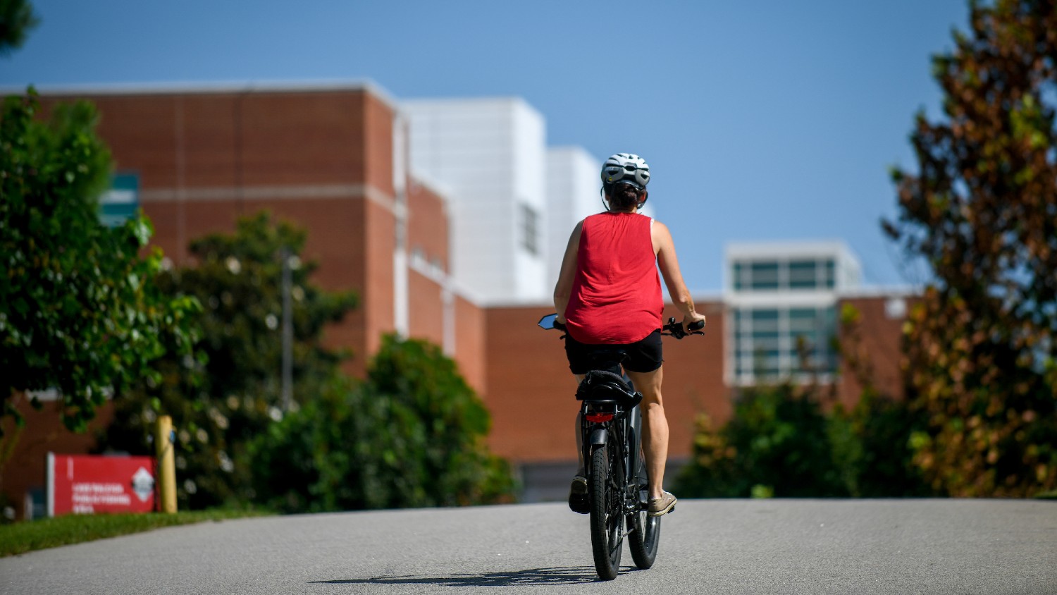Person biking on NC State's campus.