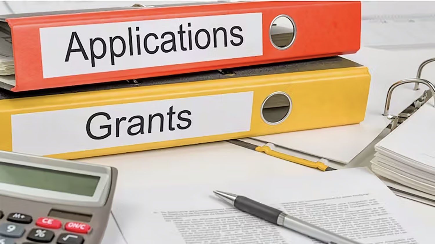 binders with the words applications and grants