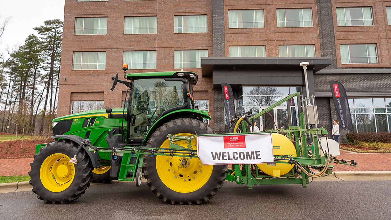 a tractor with a sign that says NC State University College of Agriculture and Life Sciences WELCOME