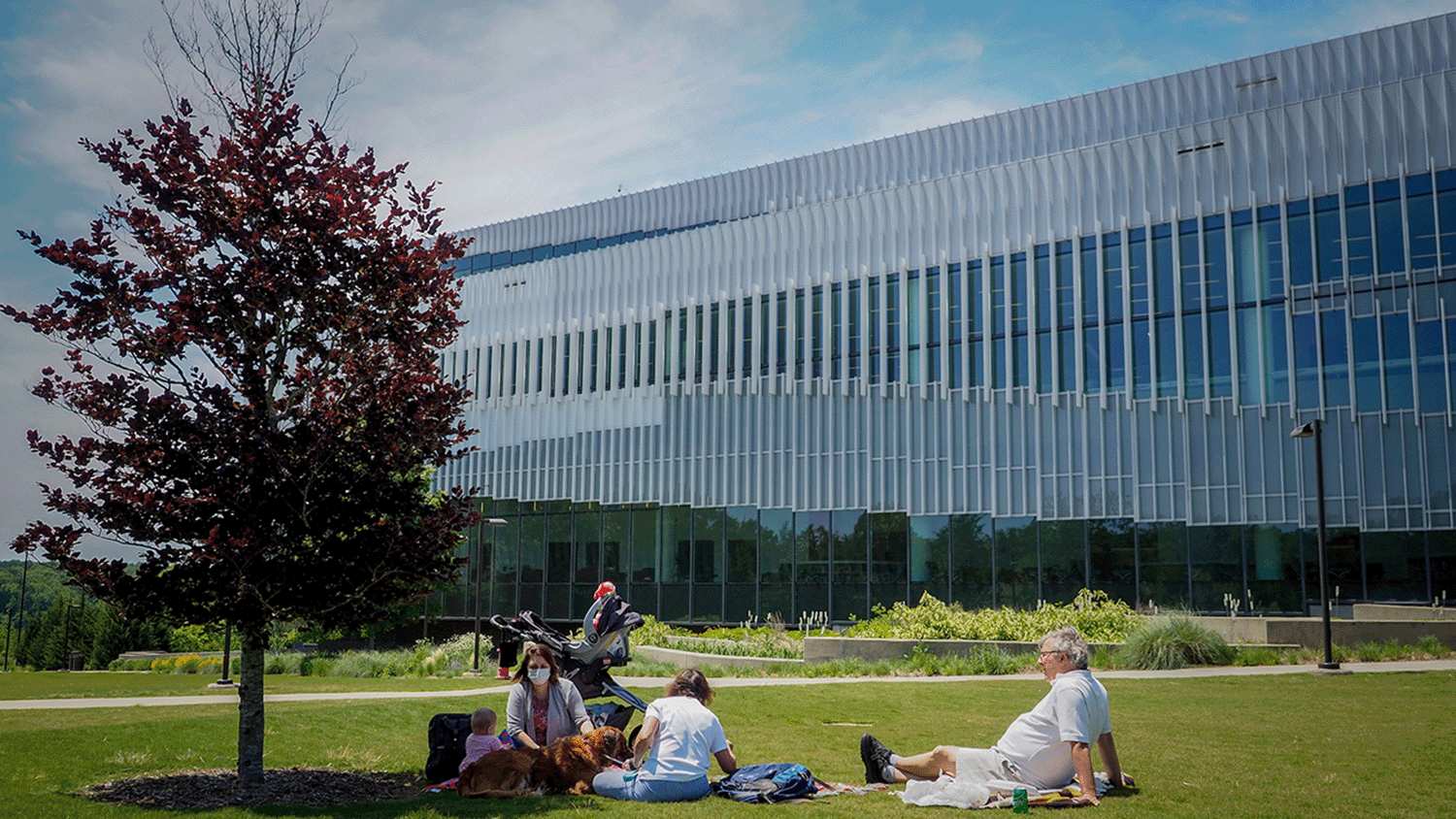 A family enjoys a picnic by the Hunt library during the COVID-19 pandemic.