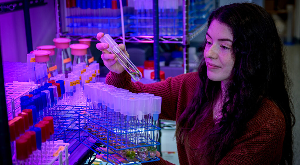 Student holding culture tubes