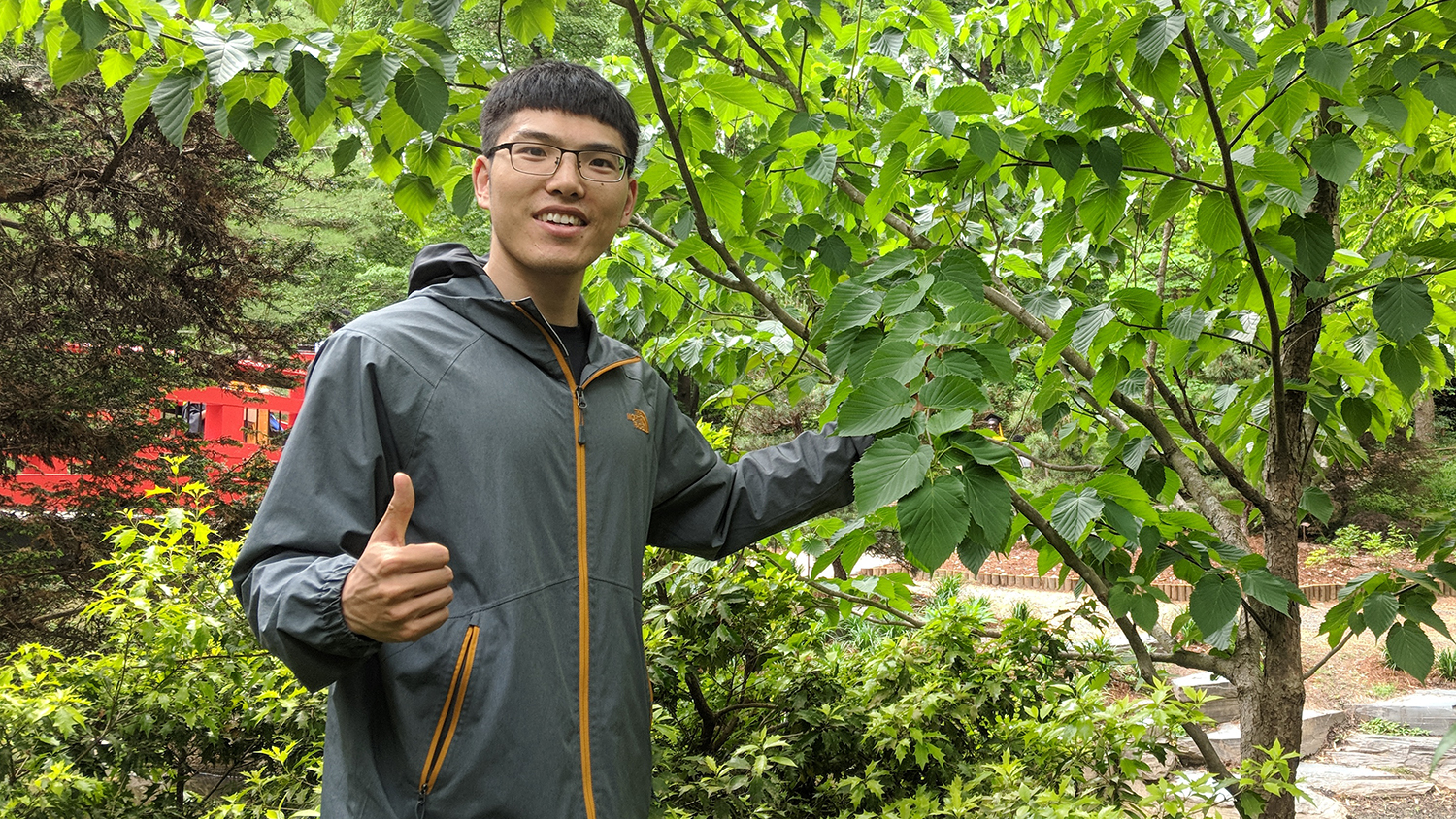 Scientist gives a thumbs-up during a visit to Duke's botanical garden.