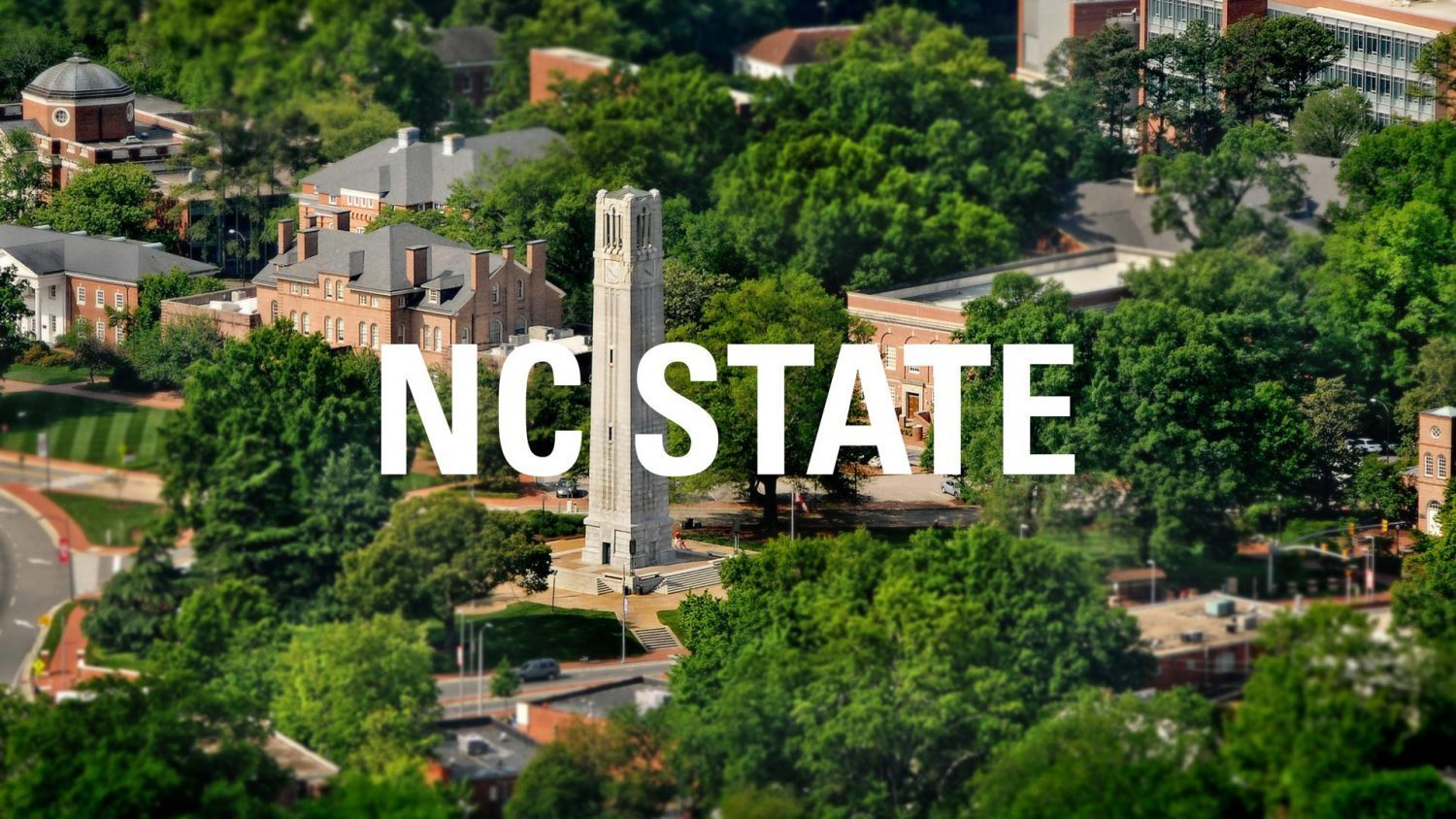 Aerial of campus with the text "NC State" across image.