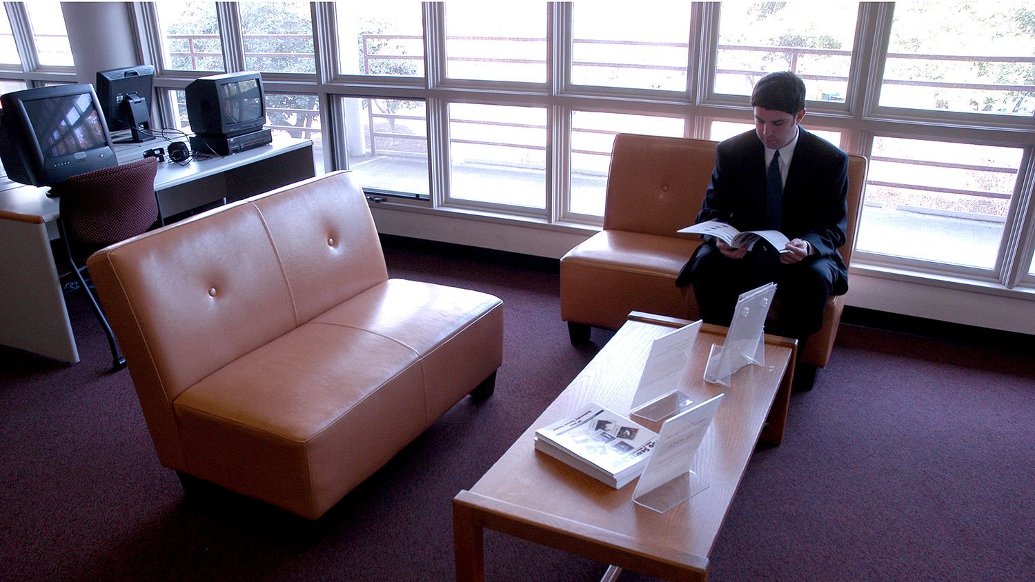 Student in a business suit waiting for an appointment at the CALS Career Center.