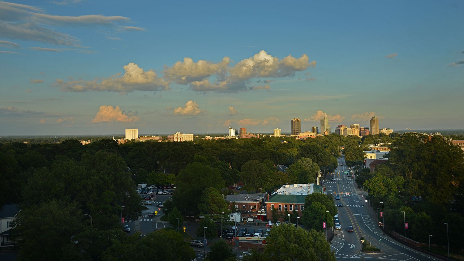 Photo of late afternoon sun in downtown Raleigh skyline.
